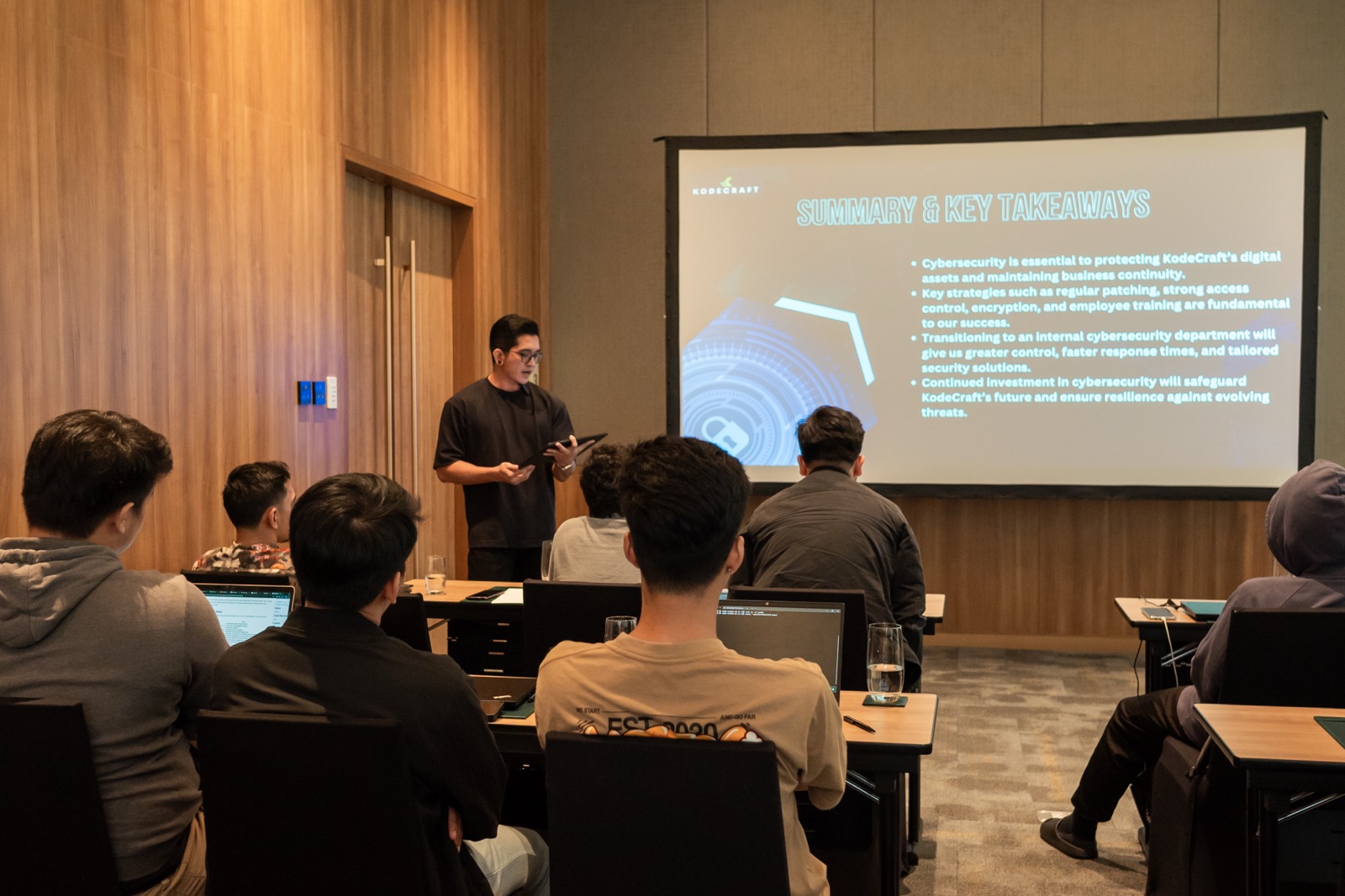 A presenter discussing software with teammates during Focus Week